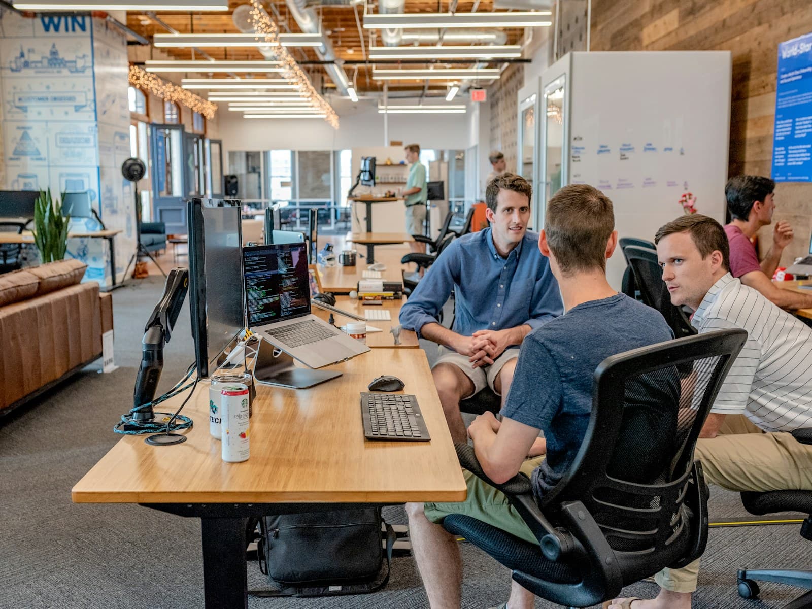 Professional software team workspace with people working together